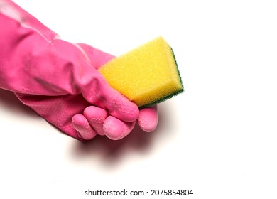 A hand in a rubber glove holds a dishwashing sponge. Cleaning concept. High quality photo - Shutterstock ID 2075854804