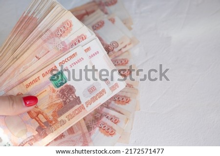 hand with Russian money . Russian roubles, russian rubles cash closeup. Rubles in cash. Finance and business background. 5000 rubles. Gas crisis concept.Selective focus