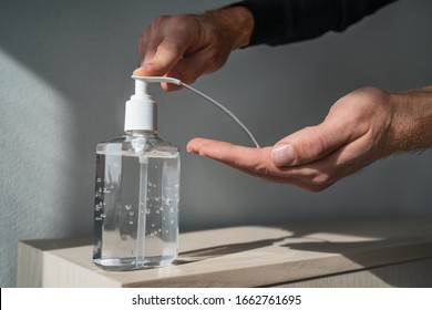 Hand sanitizer alcohol gel rub clean hands hygiene prevention of coronavirus virus outbreak. Man using bottle of antibacterial sanitiser soap. - Shutterstock ID 1662761695