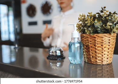 Hand Sanitizer Bottle On Hotel Reception Desk