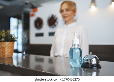 Hand Sanitizer Bottle On Hotel Reception Desk