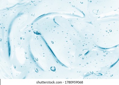 Hand sanitizer gel background. Clear colored cream with bubbles texture. Skincare hygiene product closeup