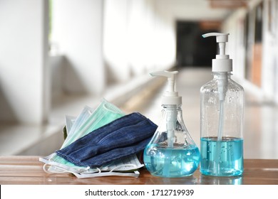 Hand sanitizer gel and facemasks in front of the office for the officers to clean hands and wear before getting inside to protect and prevent Covid-19 virus or Coronavirus , g-614 and germs. - Powered by Shutterstock