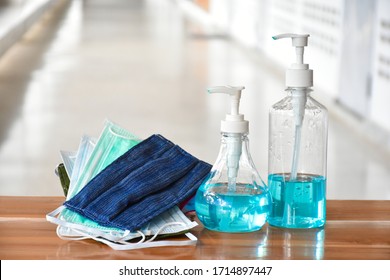 Hand sanitizer gel and facemasks in front of the office for the officers to clean hands and wear before getting inside to protect and prevent Covid-19 virus or Coronavirus and g-614 virus. - Powered by Shutterstock