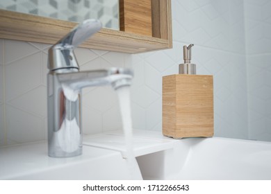Hand sanitizer or liquid soap that stands in the bathroom on the sink for regular hand washing in a pandemic. WHO recommendations. Coronavirus pandemic. COVID-19. - Shutterstock ID 1712266543