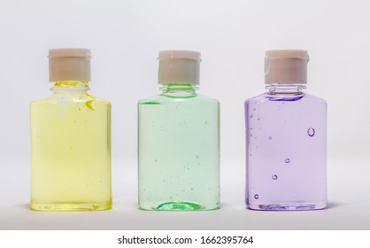 Hand Sanitizer mini travel size lemon, aloe, lavender, no label light gray background copy space