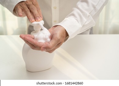 Hand sanitizer soap foam clean hands hygiene prevention of corona virus outbreak. Man using bottle of antibacterial sanitiser soap. covid-19