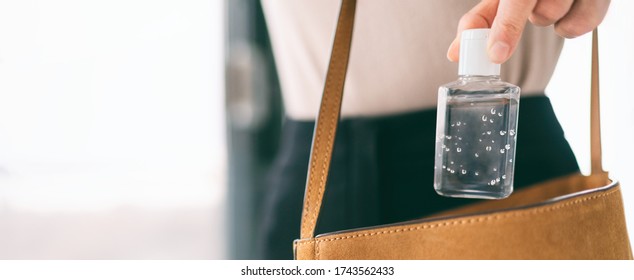 Hand sanitizer travel bottle woman carrying in purse COVID-19 prevention alcohol gel for cleaning hands while outside doing errands. Coronavirus virus pandemic banner panoramic header.
