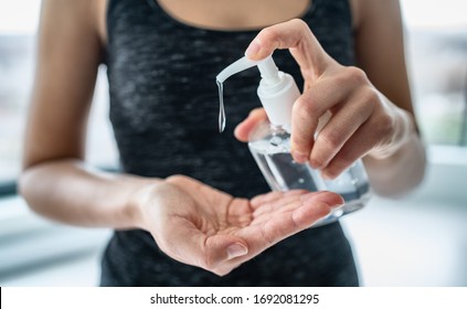 Hand sanitizer woman applying sanitizing gel liquid rubbing hands clean personal hygiene coronavirus pervention at home. Sanitiser bottle. - Shutterstock ID 1692081295