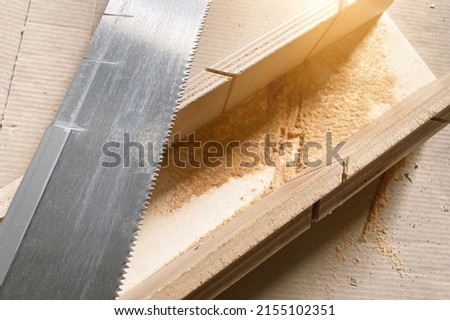 Hand saw with a shape for the correct bending angle. DIY repair at home, hand saw