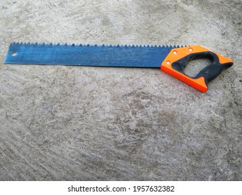 a hand saw that is unique and has a different shape from the usual with a handle that is not in the direction of the sawtooth 