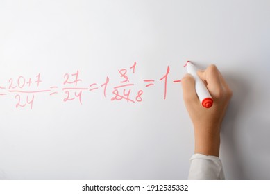 Hand Of A School Girl Counting Math Equation On A Whiteboard. School Education, Mathematics Lesson