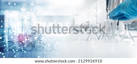 hand of scientist in blue glove with test tube and flask in medical chemistry lab and information banner background	