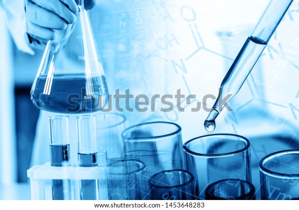 hand of scientist holding flask with\
lab glassware and test tubes in chemical laboratory background,\
science laboratory research and development\
concept