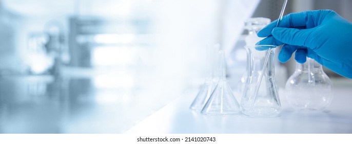 Hand Of Scientist With Test Tube And Flask In Medical Chemistry Lab Banner Background