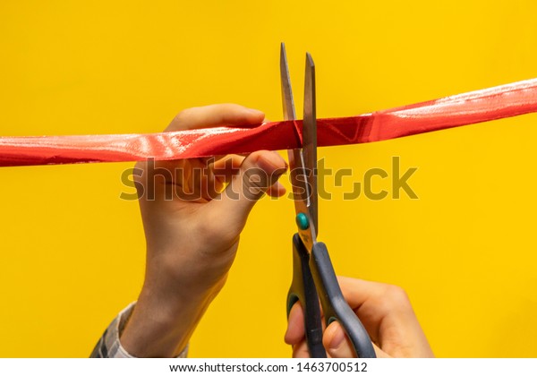 hand with scissors cut the red ribbon tape, open
ceremony concept