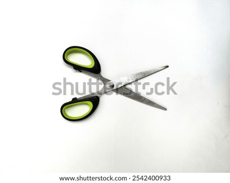 Hand scissors with handle black mixed green isolated white color
