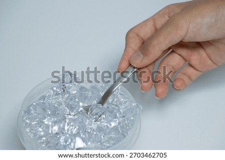 Hand scooping ice from a container