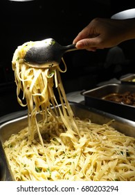 Hand Scooping Pasta Noodles From Hotel Buffet Line