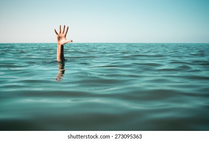 Hand in sea water asking for help. Failure and rescue concept. - Shutterstock ID 273095363