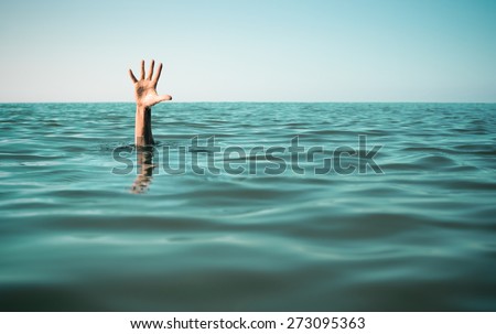 Hand in sea water asking for help. Failure and rescue concept.