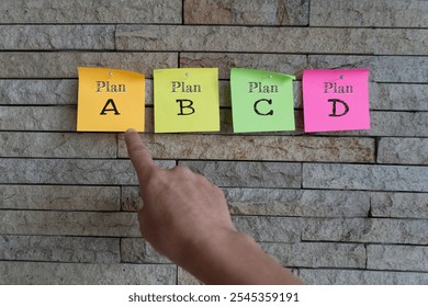A hand selects sticky notes with text 