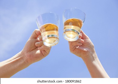 Hand of a senior Japanese couple toasting with an ice tea - Powered by Shutterstock