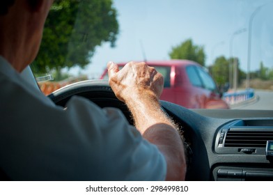 Hand Of A Senior Man Driving A Car Detail