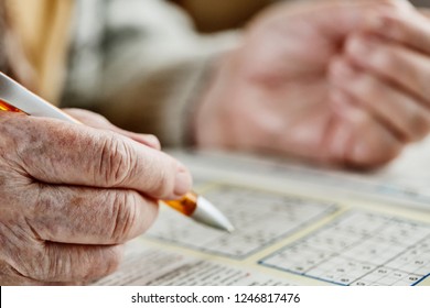 Hand Of A Senior Woman, Sudoku, Crossword