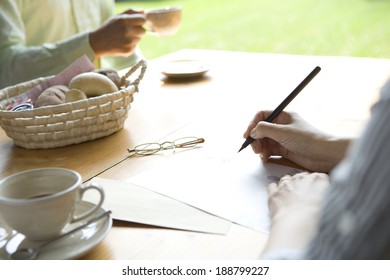 Hand Of Senior Woman Writing Letter