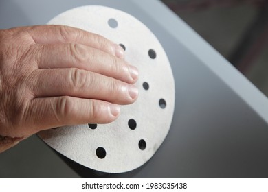 The Hand Of The Service Man Grinding A Car Body Part With A Sanding Abrasive Paper Before Painting, Vehicle Body Repair Service Preparation