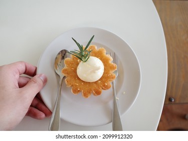 Hand Serving The Almond Lemon Cake Dessert