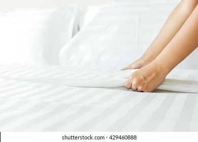 Hand Set Up White Bed Sheet In Room