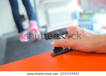 Hand setting up devise to record sporting activity