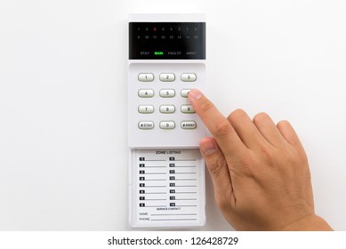 Hand Is Setting Home Security Alarm System