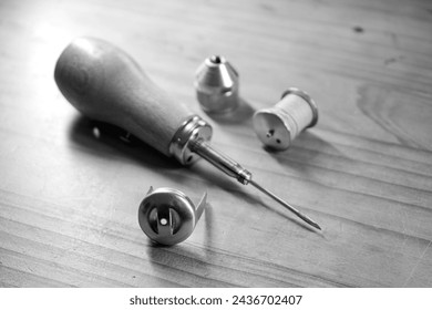 Hand sewing awl with wooden handle for repairing heavy materials, such as sails, tents or leather for repairing heavy materials. - Powered by Shutterstock