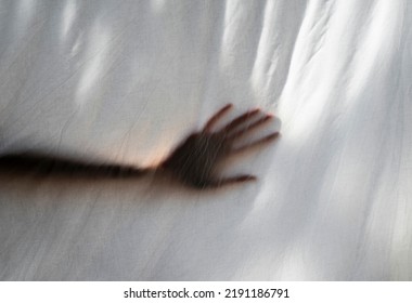 Hand Shade Behind A White Sheet Of Anonymous Person. Concept About Mental Health And Illness, Isolation, Anxiety, Stress, Imprisonment.