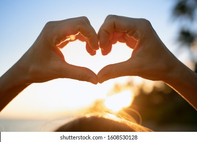 Hand Shaped Heart At Sunset. 