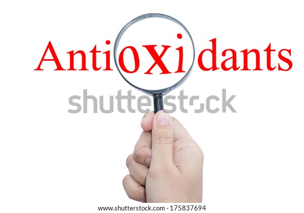 Hand Showing Antioxidants Magnifying Glass