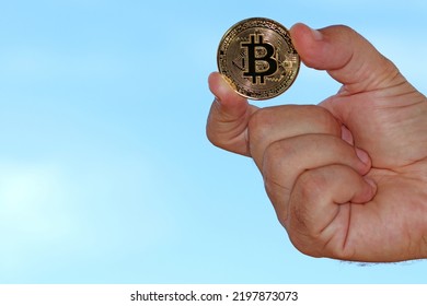 Hand Showing A Bitcoin Coin