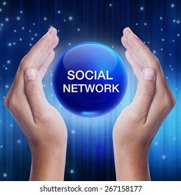 Hand Showing Blue Crystal Ball With Social Network Word. Business Concept