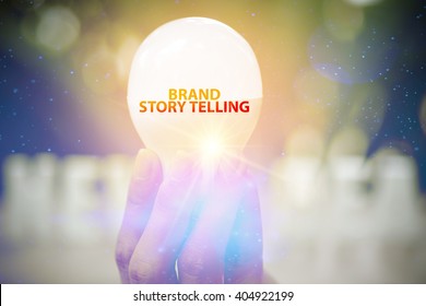Hand Showing BRAND STORY TELLING  Text On Light Bulb , Business Concept 