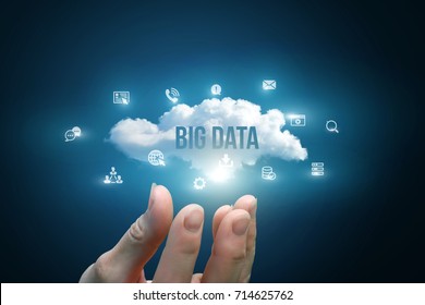 Hand Showing A Cloud With The Words Big Data On Blue Background.