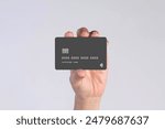 Hand showing credit card, or card, or business card or voucher, isolated on white background, template, mock-up