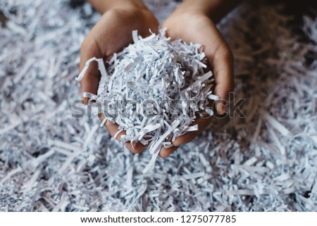 hand showing heap of shredded paper. Concept of recycle and office work of confidential