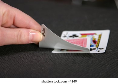 hand showing playing cards on table