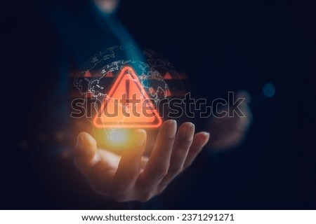 Hand showing red triangle caution warning sign and global for maintenance notification error and risk concept, protecting data personal information on social network. data security, risk management