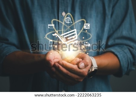 Hand showing virtual info graphics with trolley cart and shopping, business, finance icons , Technology online shopping business concept. ecommerce, e-payment, make payment online transection.
