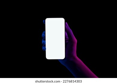 Hand shows blue and pink neon lights bezel-less smartphones on black background. - Powered by Shutterstock