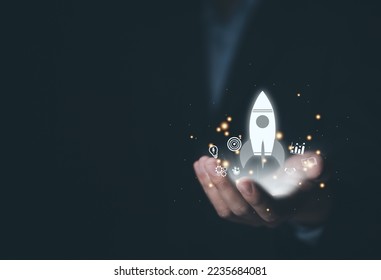 hand shows a rocket and an icon. Concept of Startup Business, Entrepreneurship Idea, and Online Digital Business. network connection on the interface Online Marketing, Technology and Success